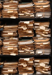 Paper Documents Stacked In Archive