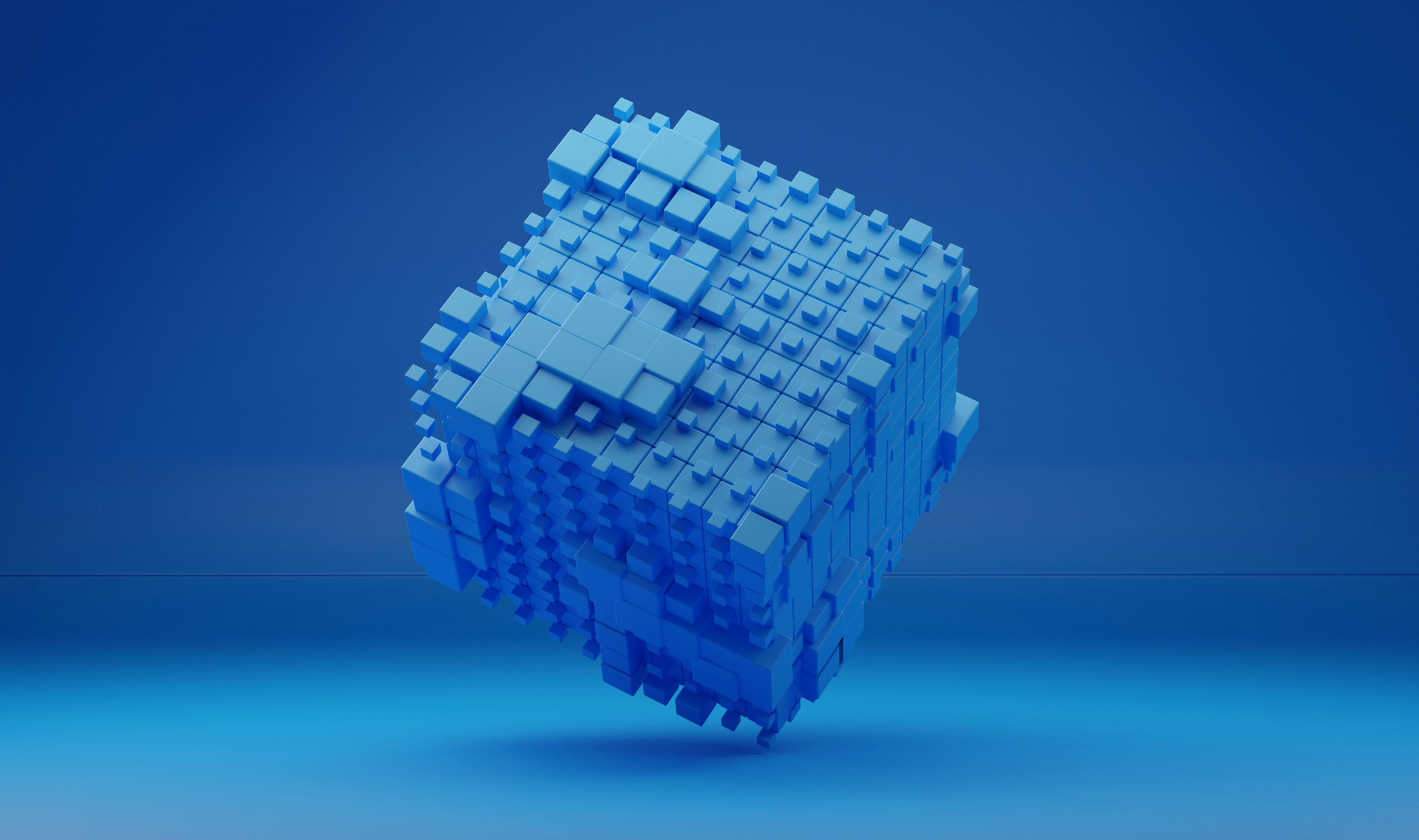 Data archiving is represented by a large vibrant blue cube made up of smaller blue cubes against a blurry blue background.