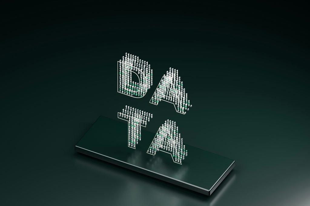 Small white and greens items formed to spell out the word data in capital letters floating at an angle in space above a metallic platform